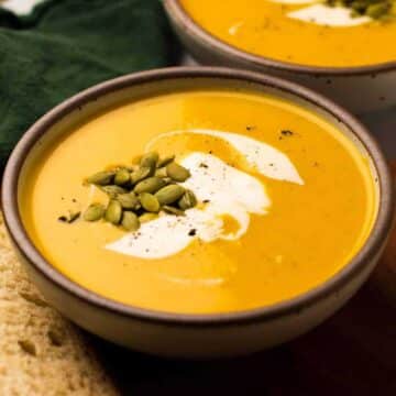 Butternut squash soup topped with seeds and a touch of cream.