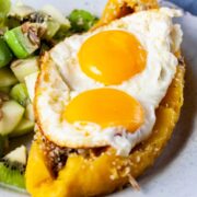 Microwaved softened sweet plantain topped with sunny side-up eggs.