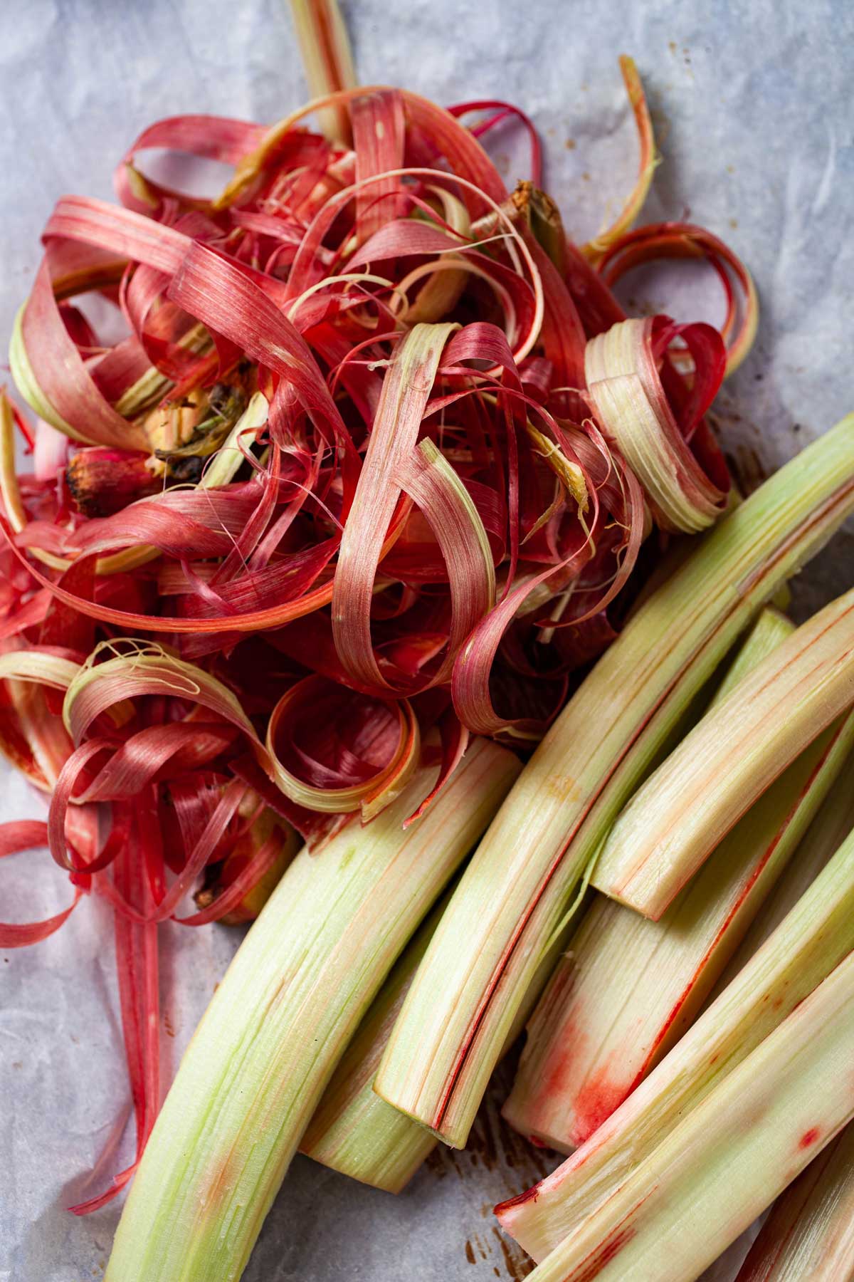 Peeled raw rhubarb on a table.