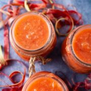 Strawberry rhubarb sauce in glass jars.