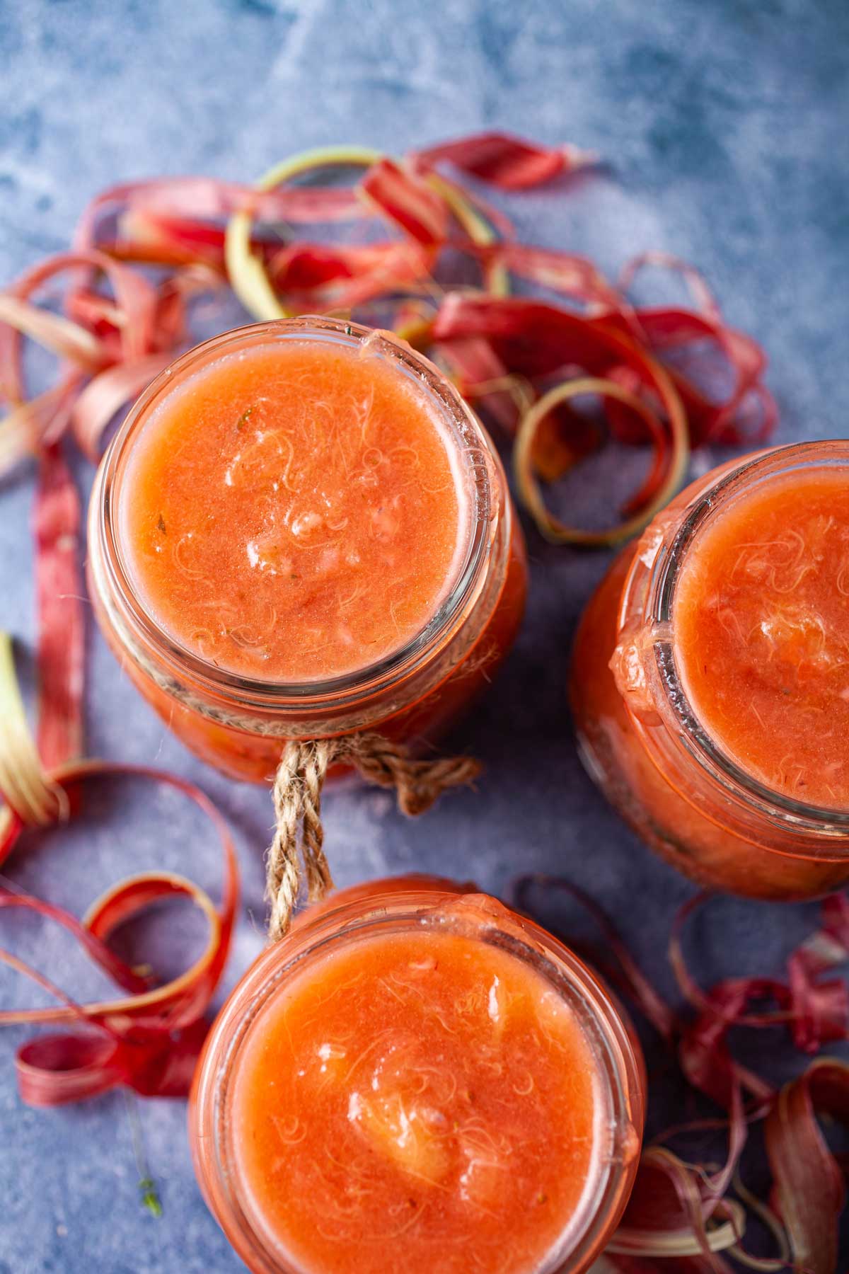 Strawberry rhubarb sauce in glass jars.