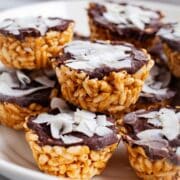 Peanut butter chocolate rice crispy treats stacked on a plate.