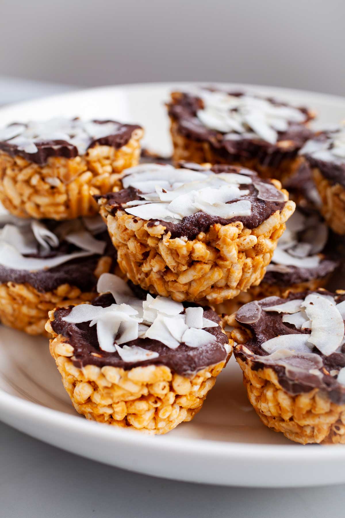 Peanut butter chocolate rice crispy treats stacked on a plate.