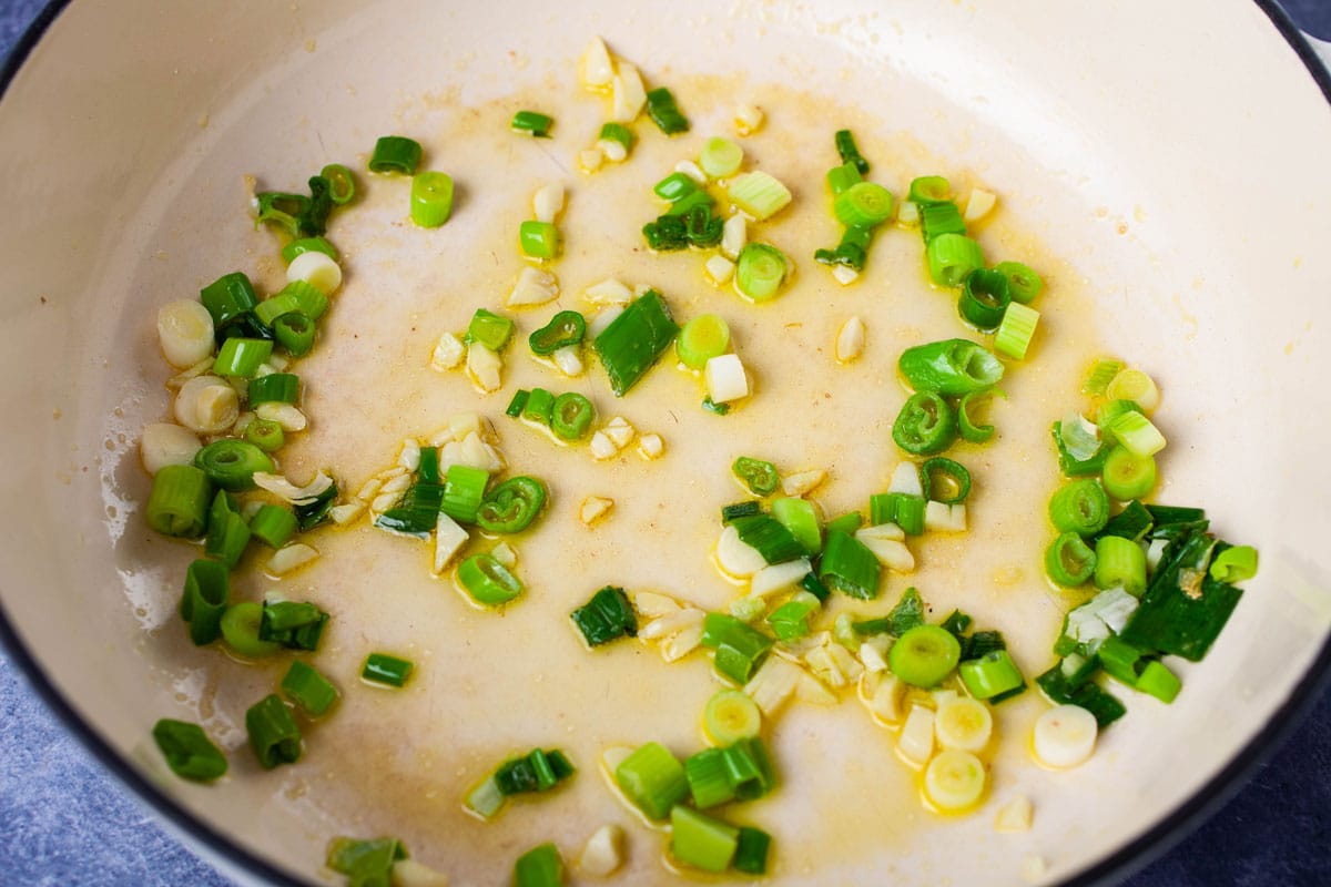 Chopped green onions, chopped garlic and olive oil in a Dutch pan.