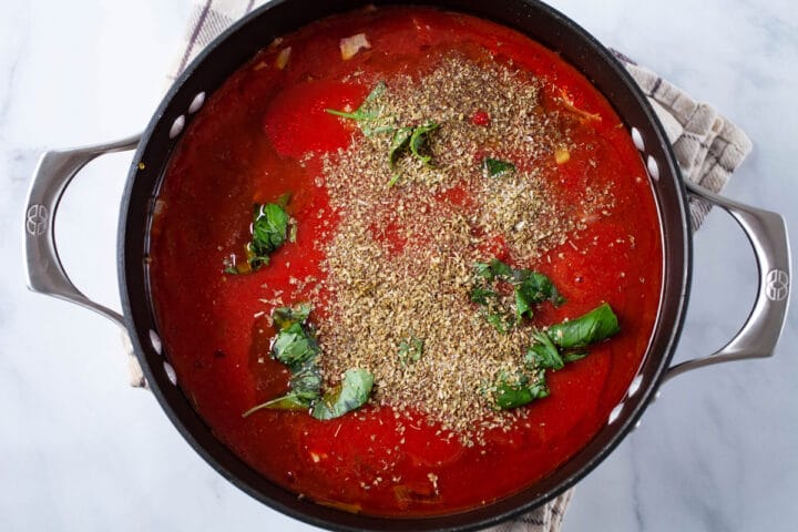 A large pot containing authentic seasoned Italian red sauce.