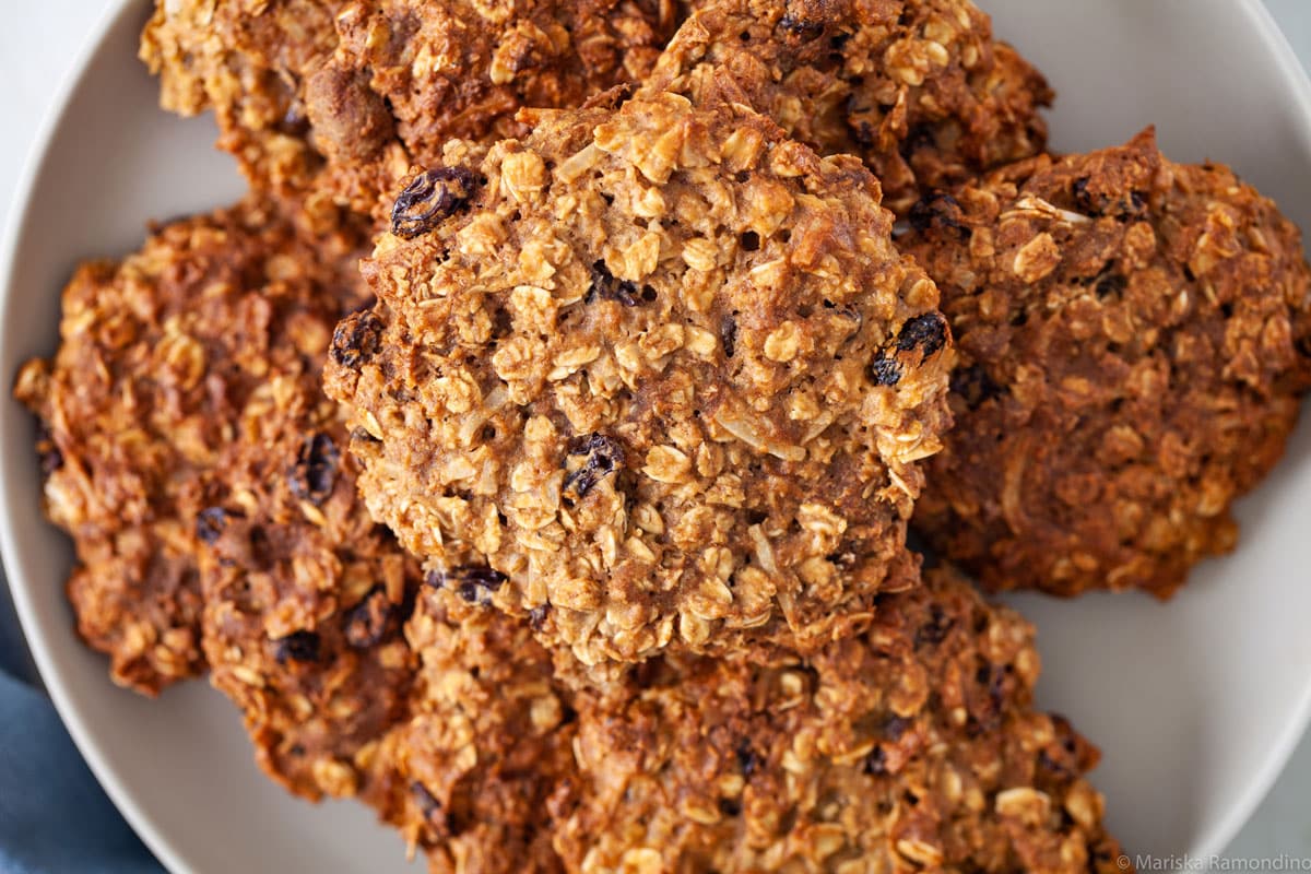 The best gluten-free oatmeal raisin cookies stacked on a plate.
