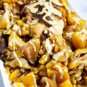 A beautiful dish with a whole chicken and potatoes topped with a healthy gravy.