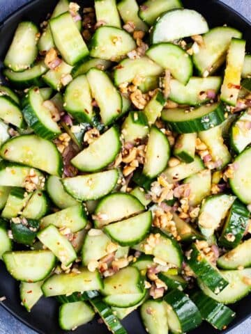 Chopped cucumbers and onions topped with a spicy dressing and chopped peanuts.