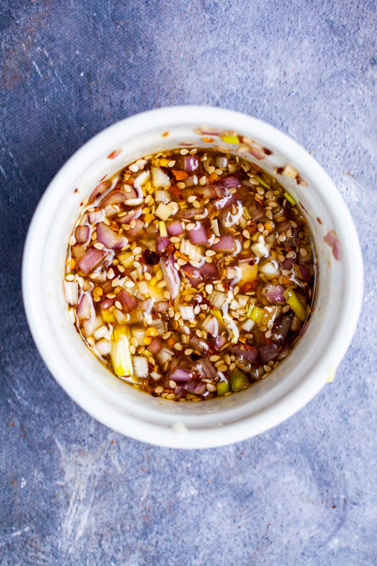 An onion and garlic based dressing in a small bowl.