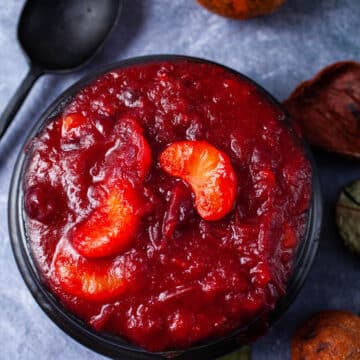 A black bowl containing mandarin orange cranberry sauce.