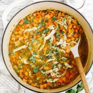 Sweet potato and shredded chicken soup in a Dutch oven pan.