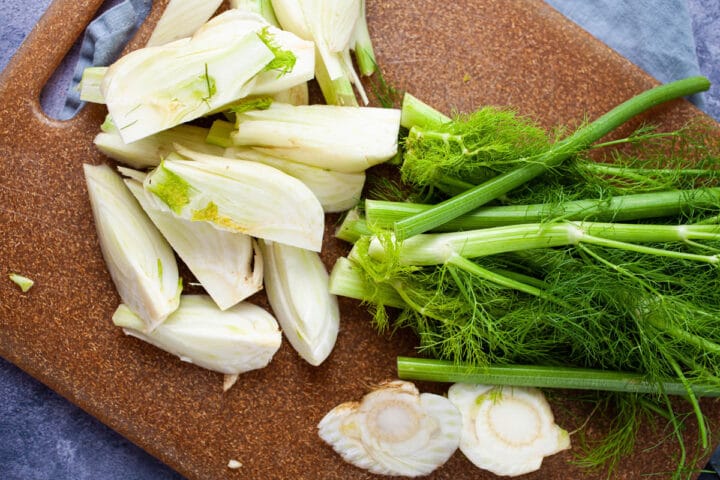 Fresh fennel cleaned up and cut, displayed on a cutting board.