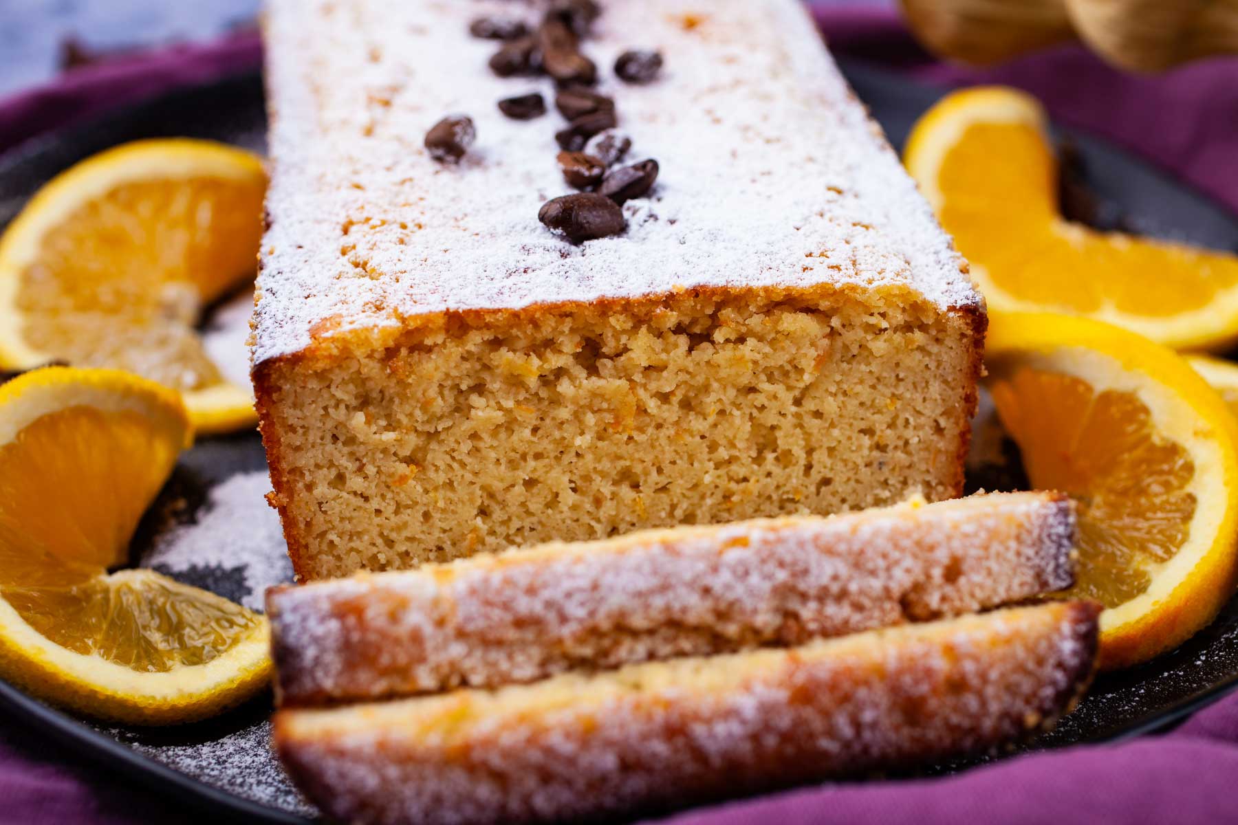 A sliced almond flour coffee cake on a plate.