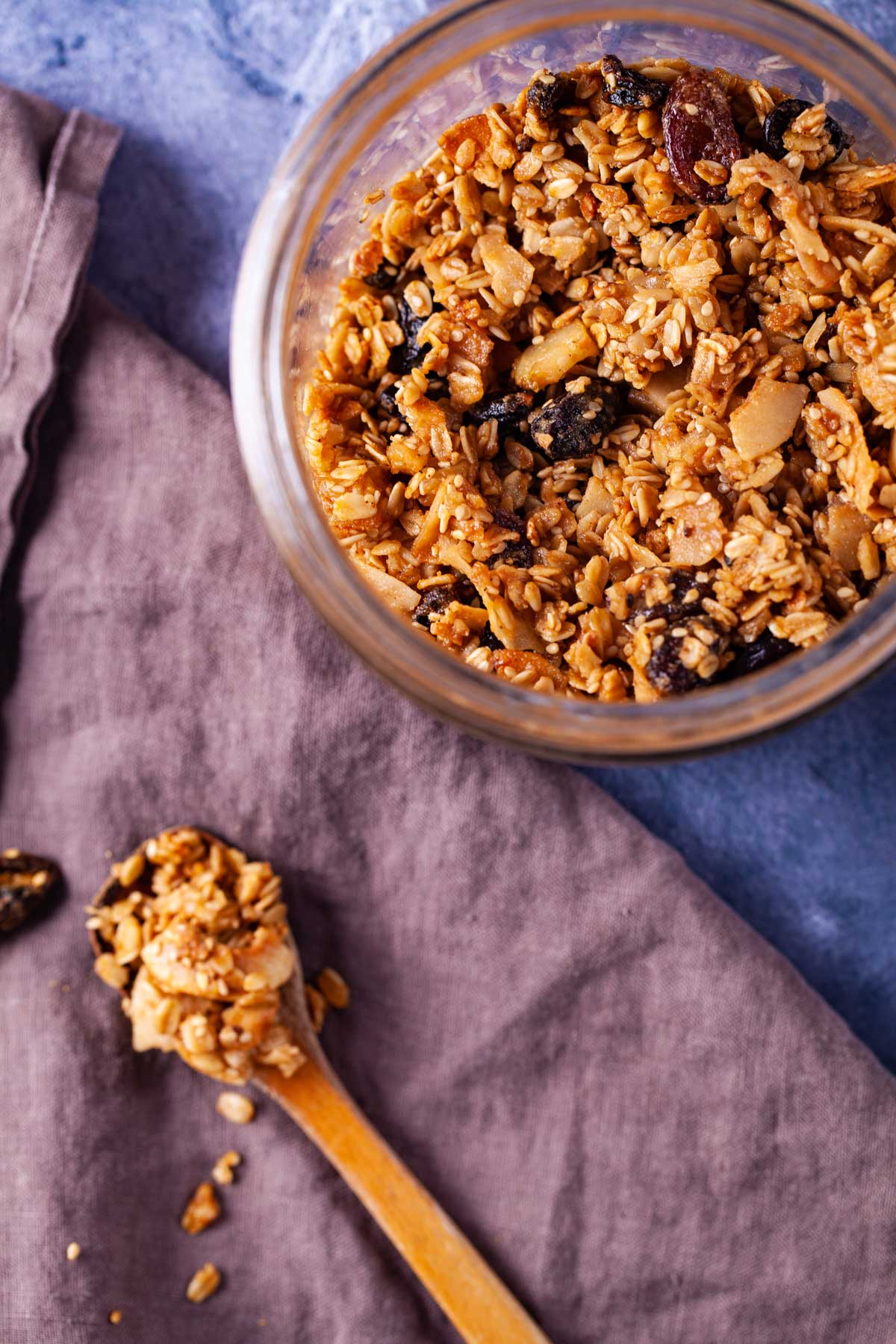 Homemade granola stored in a glass jar with jumbo raisins.