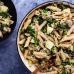 A large Dutch oven pan filled with sausage and broccoli rabe pasta.