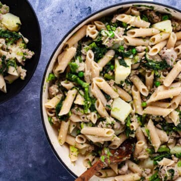 A large Dutch oven pan filled with sausage and broccoli rabe pasta.