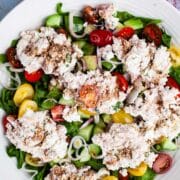 A large serving plate with a tuna cucumber salad with ricotta cheese.