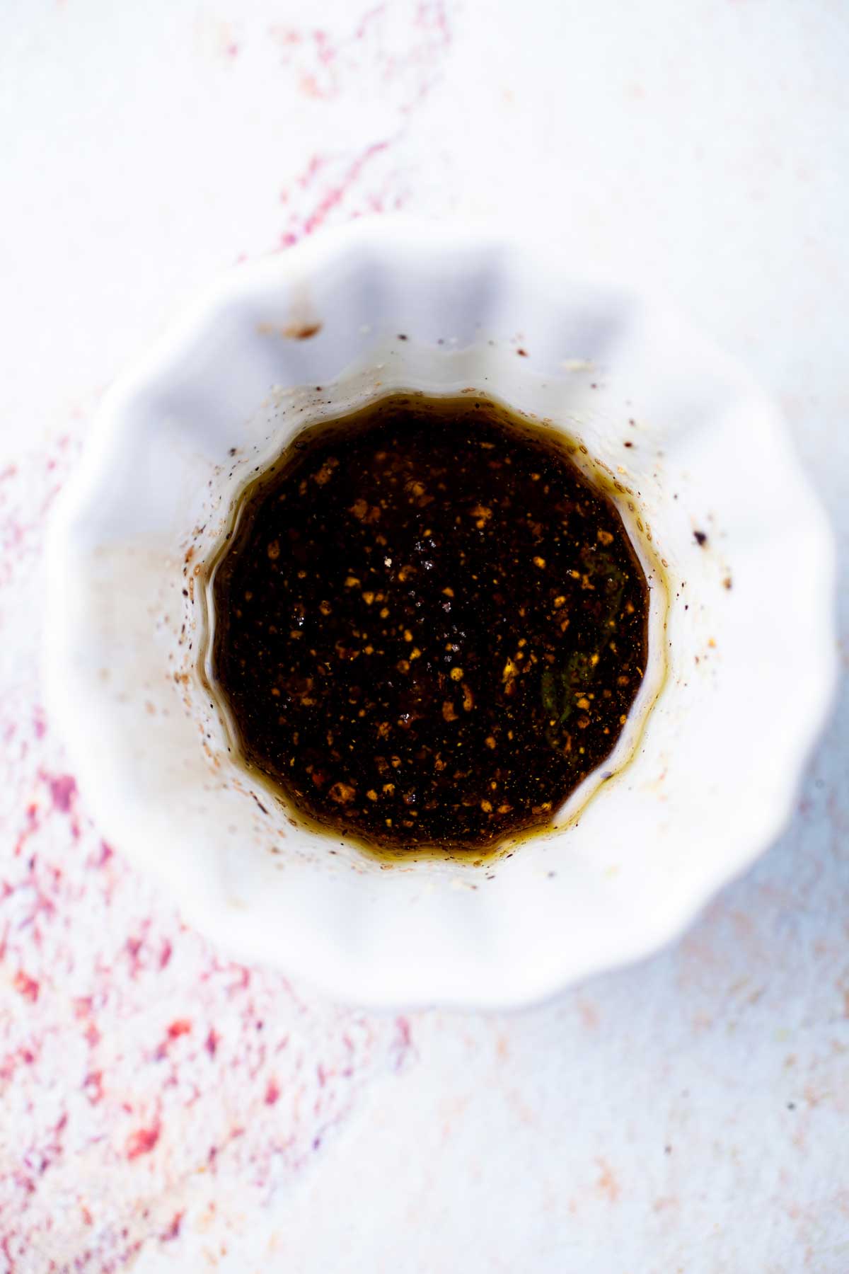 A small bowl with a balsamic vinegar and olive oil mixture.