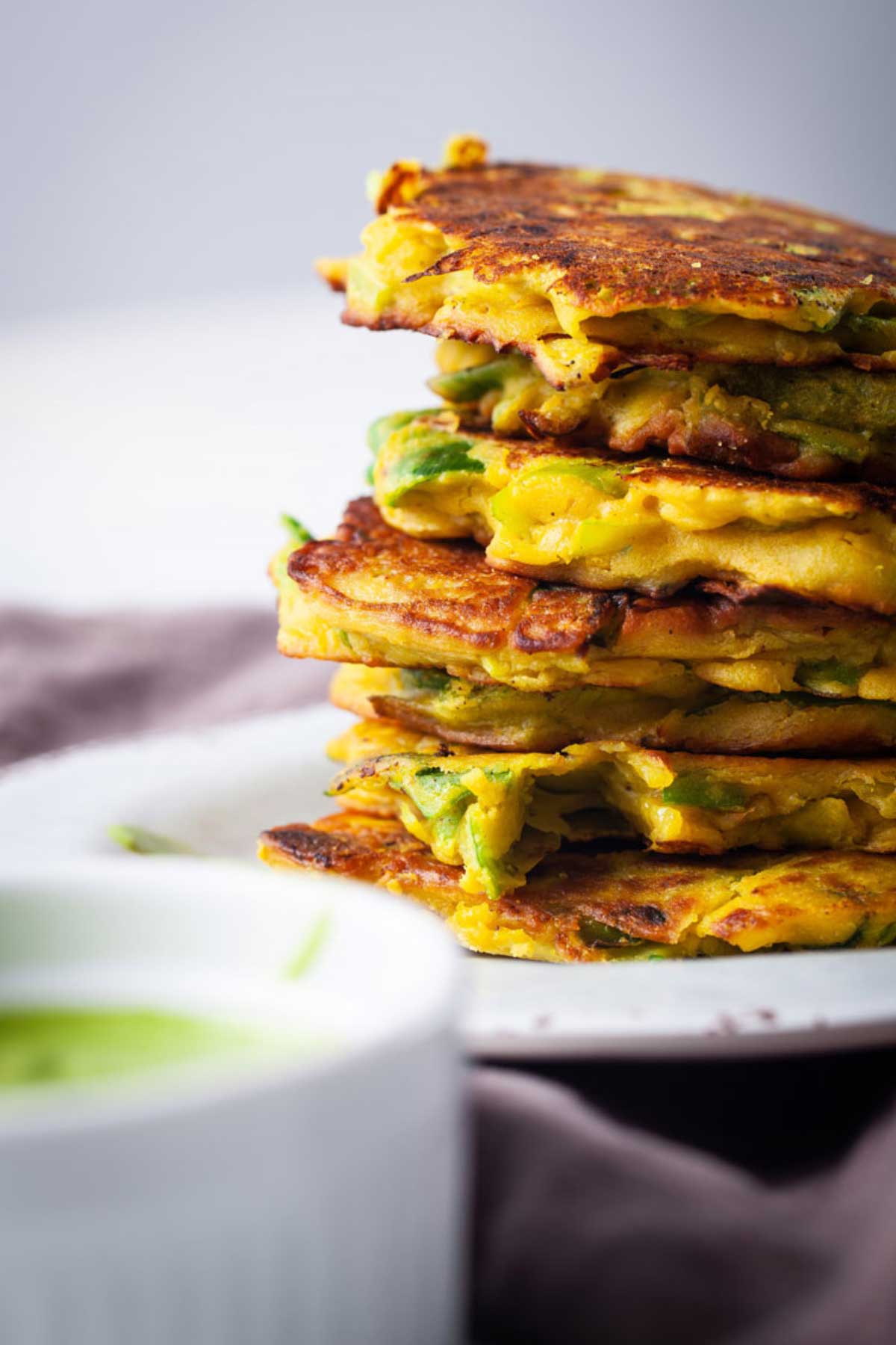 Gluten-Free leek fritters stacked on top of each other.
