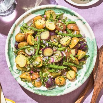 Green beans and potato salad on a large serving plate.