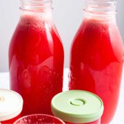 Watermelon and ginger juice in glass bottles.