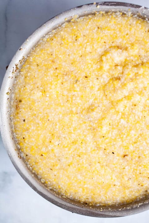 Creamy, cooked and seasoned polenta in a large pot.