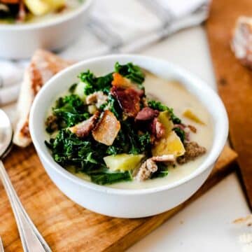 A small soup bowl topped with kale and bacon bits.