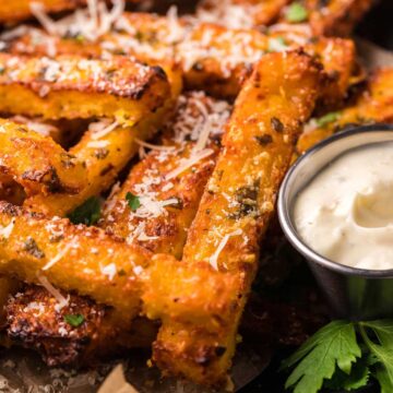 Golden brown fries topped with cheese.