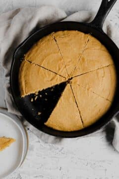 Sliced cornbread in a cast-iron skillet.