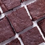 Squared chocolate brownies sorted on a napkin.