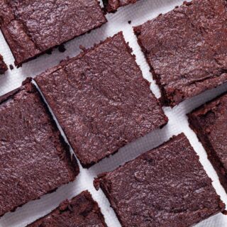 Squared chocolate brownies sorted on a napkin.