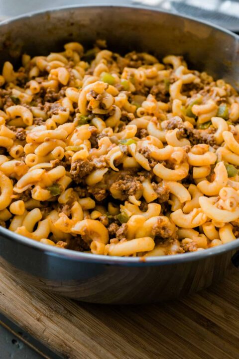 bison hamburger helper in a metal pot sitting on a wooden surface.